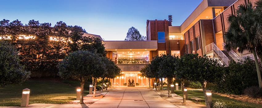 Mitchell College of Business at night.