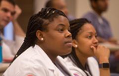 Student with white coats on in class